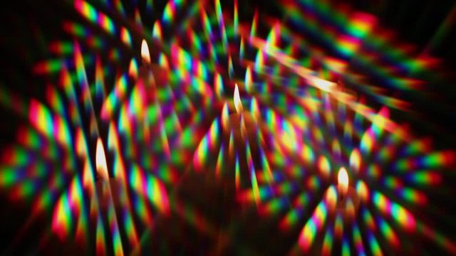 Diffraction of light from a candle flame as a set of diffraction orders, obtained using two crossed  diffraction gratings. The flame oscillates under the blow of air movement