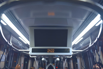 Indoor advertising in public transport. Bus cabin with lcd monitor on ceiling.