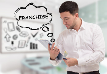 Business, technology, internet and network concept. The young businessman comes to mind the keyword: Franchise