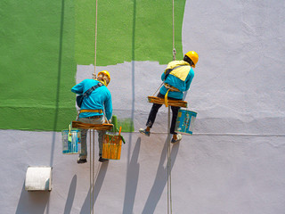 Painters painting exterior of building