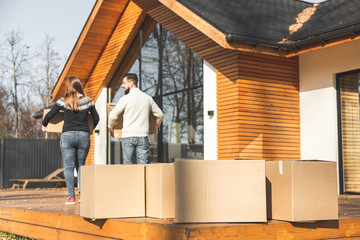 Fototapeta premium young couple moves to a new home. the family carries boxes of things after buying a home.
