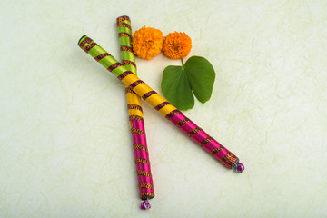 Indian Festival Dussehra, showing golden leaf (Bauhinia racemosa) and marigold flowers with Dandiya sticks.