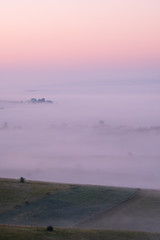 Sunrise on the mountain with morning fog in the valley.