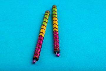 Dandiya sticks on a blue background. Raas Garba or Dandiya Raas is the traditional folk dance form...