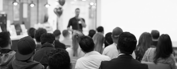 Conference photo audience and speaker giving speech. Seminar presenter on a panel during forum....