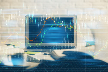 Financial graph colorful drawing and table with computer on background. Multi exposure. Concept of...