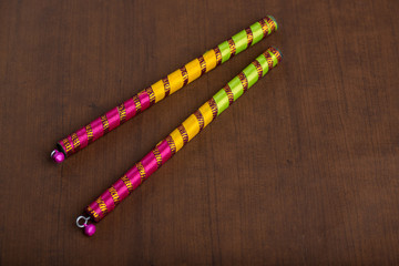 Dandiya sticks on a brown background. Raas Garba or Dandiya Raas is the traditional folk dance form...