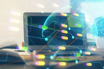 Multi exposure of table with computer and world map hologram. International data network concept.