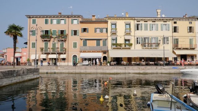 People and Tourists on Lake Walk in Lasize, Garda Lake, Italy.