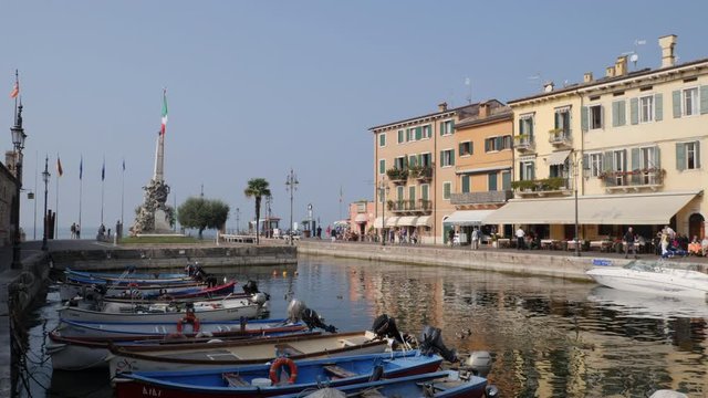 People and Tourists on Lake Walk in Lasize, Garda Lake, Italy.