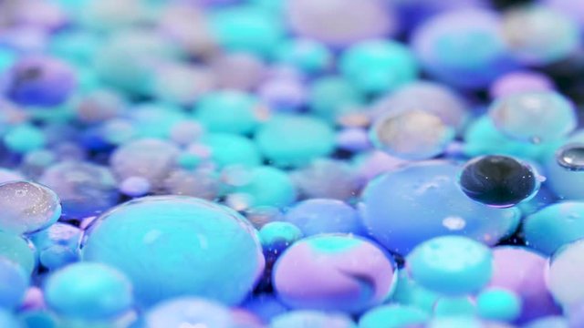 Bright collors bubbles moves in slow motion in oil with acrylic