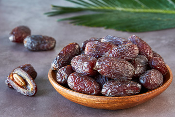 Dried dates fruit in wooden bowl 