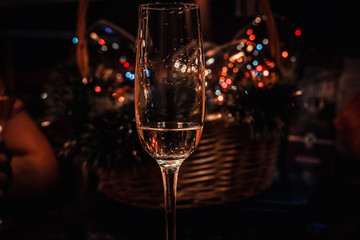 crystal glasses stand against the backdrop of beautiful Christmas decorations