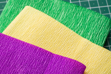 Roles of grunge paper on a green cutting mat