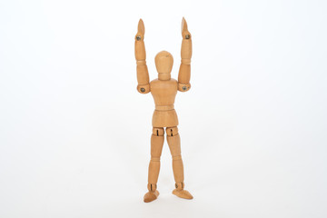 Wooden figure pose raised hands on white background isolated object