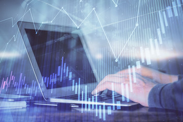 Double exposure of forex chart with man working on computer on background. Concept of market analysis.