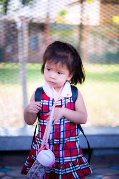 Portrait of Asian baby girl. Upset face  child. Vertical image.