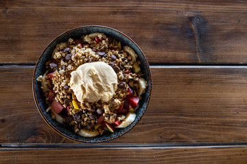 Fruit salad with slices of banana, blackberries, watermelon, peaches and nuts, yogurt sauce