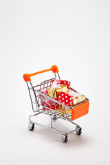 Shopping cart filled with Christmas gift box presents