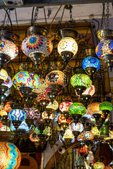 detail of some little coloured lamps hanging on the ceiling of a tourist shop in valencia