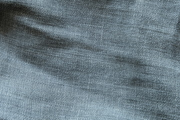 Heavy used blue grey jean denim top view close up shot to the detail of fabric. textile material and cotton patter tough and durable garment style. For background or wallpaper with copy space for text