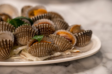 Steamed cockle ( Boiled cockles ) seafood served on white disk.