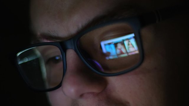 A man watches erotic content on the Internet. Point reflection