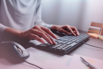 2 hands of Asian woman is press, typing on 2 language keyboard as Thai and English. Maybe preparation about information to report, chat to lover or shopping online by connect to internet at home, cafe