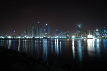 Fototapeta na wymiar Reflexion of tall buildings in Dubai