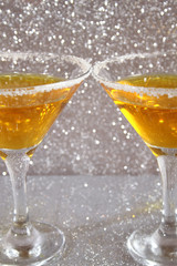 Two glasses with a yellow cocktail
