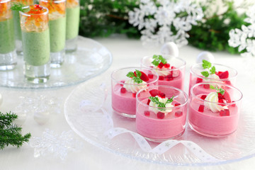 Christmas appetizers, mousse with beetroot , avocado and spinach in glasses.