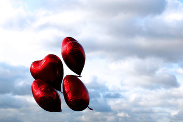 flying red balloons in the sky, heart shaped balloons 