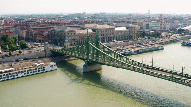 Liberty Bridge and Budapest city, Aerial establishing pan over Danube river