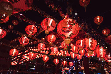 Red Chinese lantern(Translation Hieroglyph text Happy New Year) hanging in a row during day time for Chinese new year celebration.