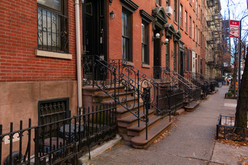 Row of Old Brick Residential Buildings along the Sidewalk in Hell's Kitchen New York