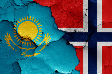 flags of Kazakhstan and Norway painted on cracked wall