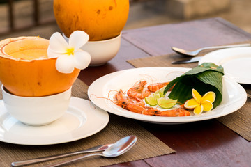 Delicious asian food served on the terrace with coconuts