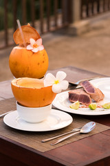 Delicious asian food served on the terrace with coconuts