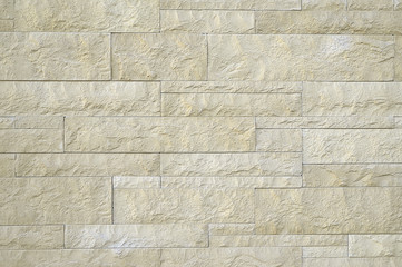 Old beige stone wall background texture