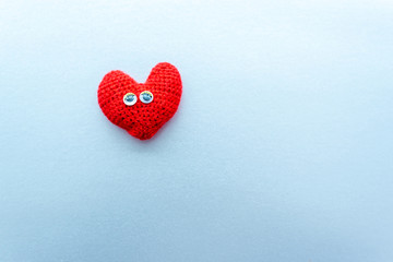 Red heart with eyes on the silver background. Merry emotions. Valentines Day, wedding, love.