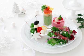 Plate of assorted festive appetizers.  Avocade and spinach mousse,Beetroot mousse, Roast beef salad,Mozzarella sticks.