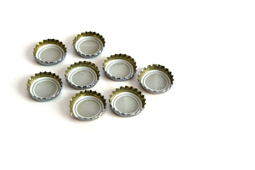 many soda bottle caps in the hand of a person,