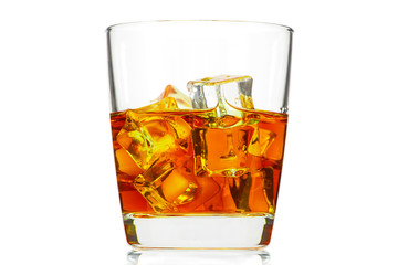 A glass of whiskey with ice or brandy and a square carafe isolated on a white background. Whiskey with ice in a glass against white background.