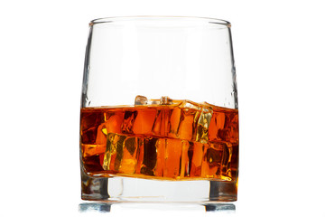 A glass of whiskey with ice or brandy and a square carafe isolated on a white background. Whiskey with ice in a glass against white background.