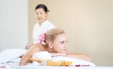 Foreign woman are happy and relaxed with Thai massage by a professional Thai masseuse. Oil massage is one of the world famous relaxation. (call Nuad Thai, traditional Thai massage ).