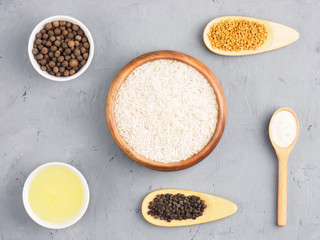 Ingredients for cooking basmati rice: butter, allspice, fenugreek, salt, black pepper. Healthy eating concept