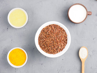 Ingredients for cooking brown rice: butter, yogurt, turmeric, cumin (jeera), salt. Healthy eating concept