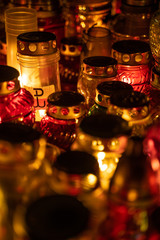 Close-up on candle with Warsaw uprising symbol in a sea of candles