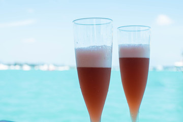 Two glasses with background of sea and sky