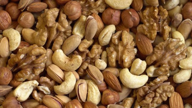 Collage of kernels of nuts. Macro. Clockwise rotation. 4K.